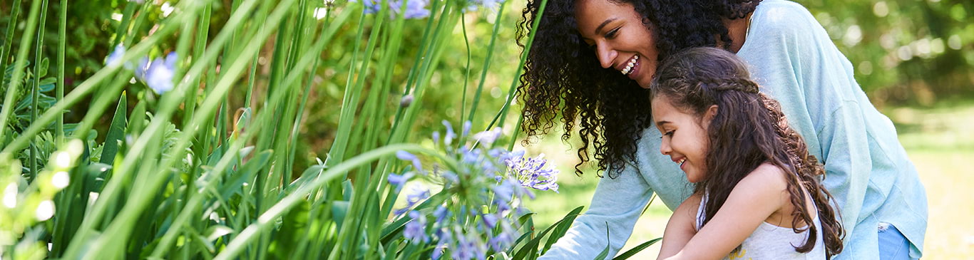 Mother and daughter picking flowers