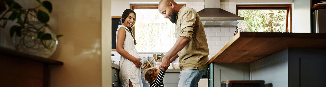 Family laughing and dancing in kitchen