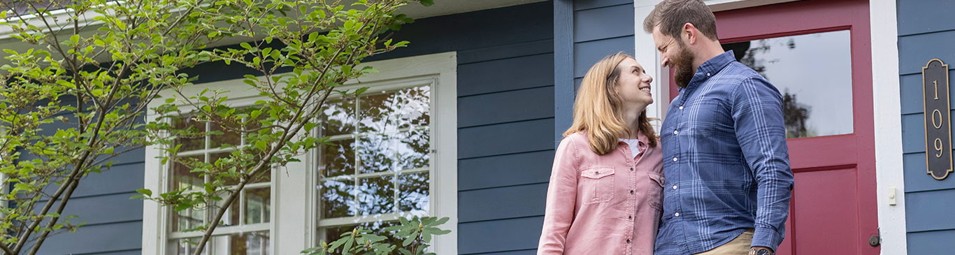 Couple in front of new house