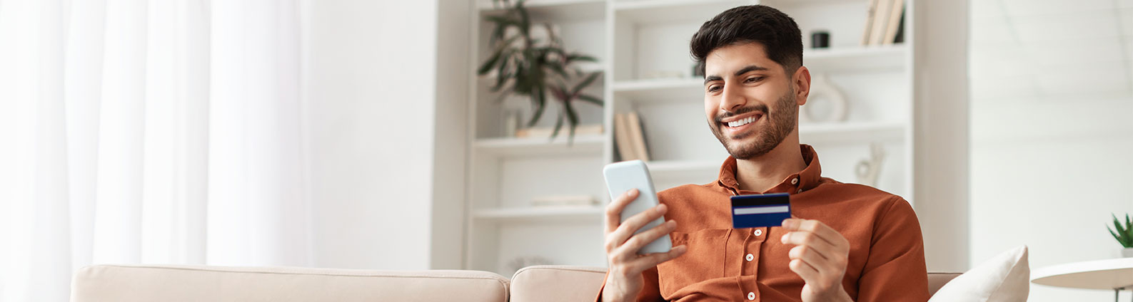 Man paying with a credit card on his phone