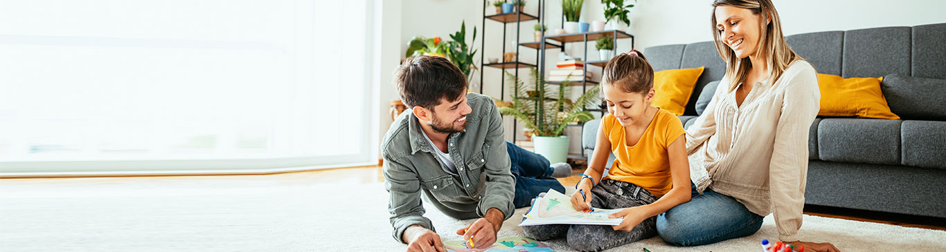 family in living room coloring together