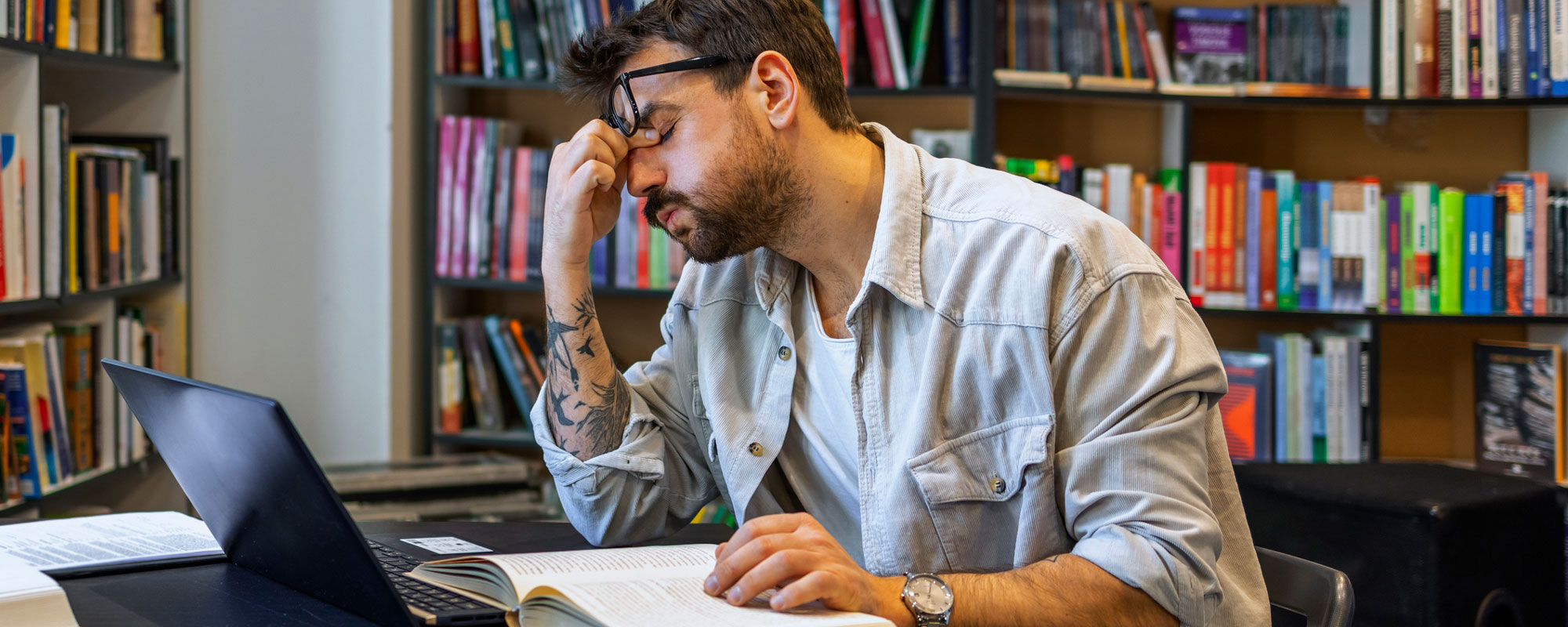 Stressed student looking at laptop