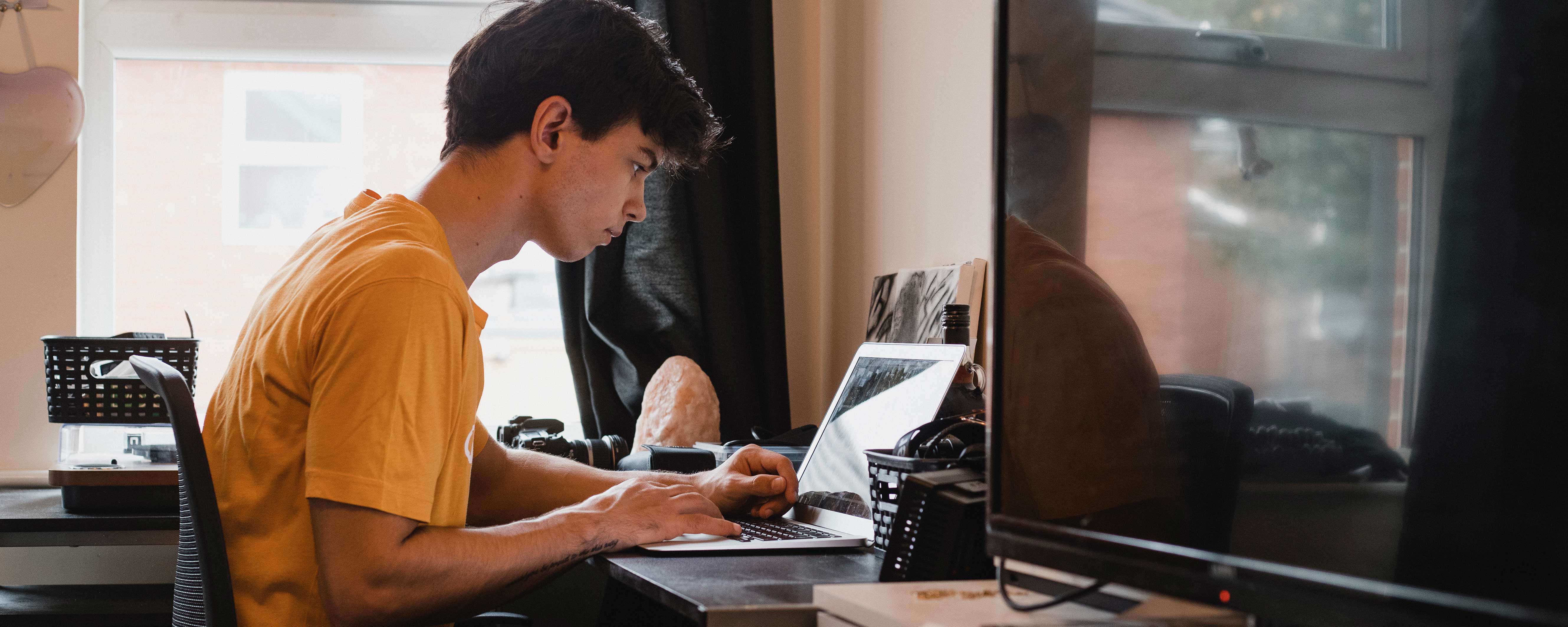 boy studying in dorm room