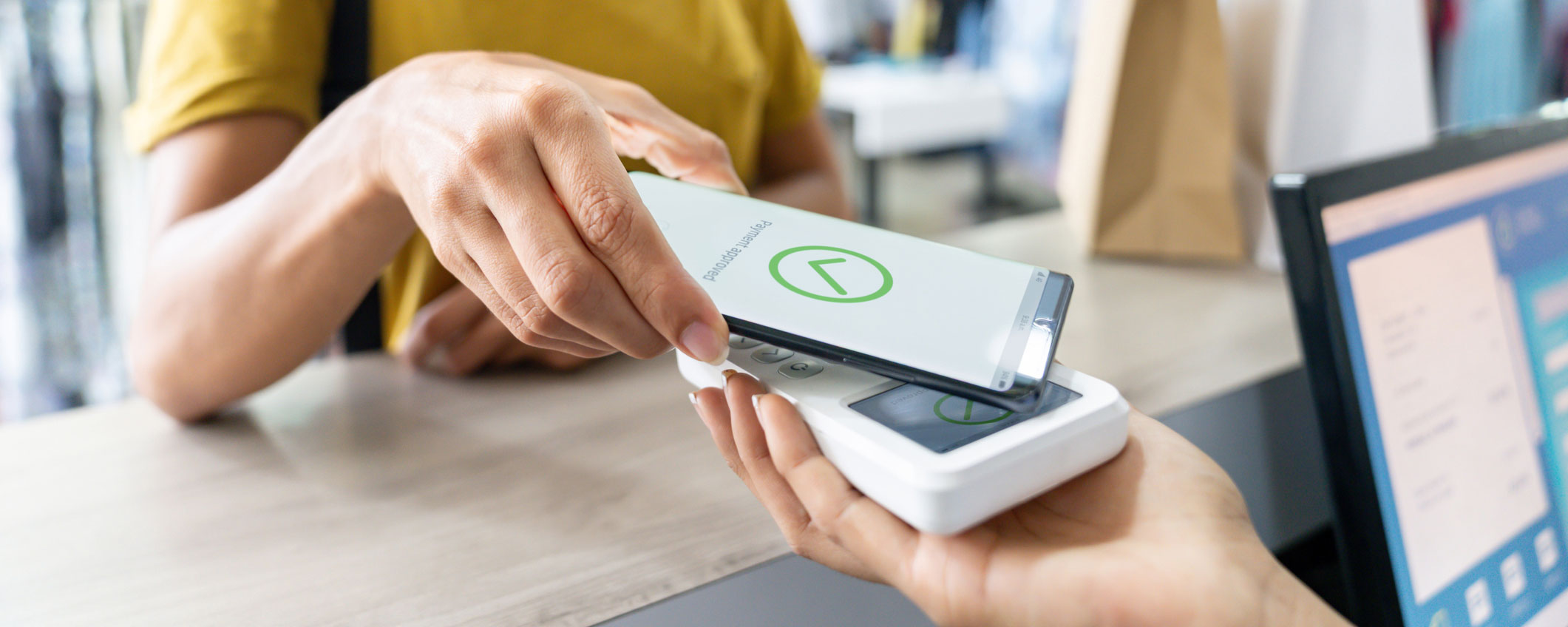 Woman making a mobile payment at a store