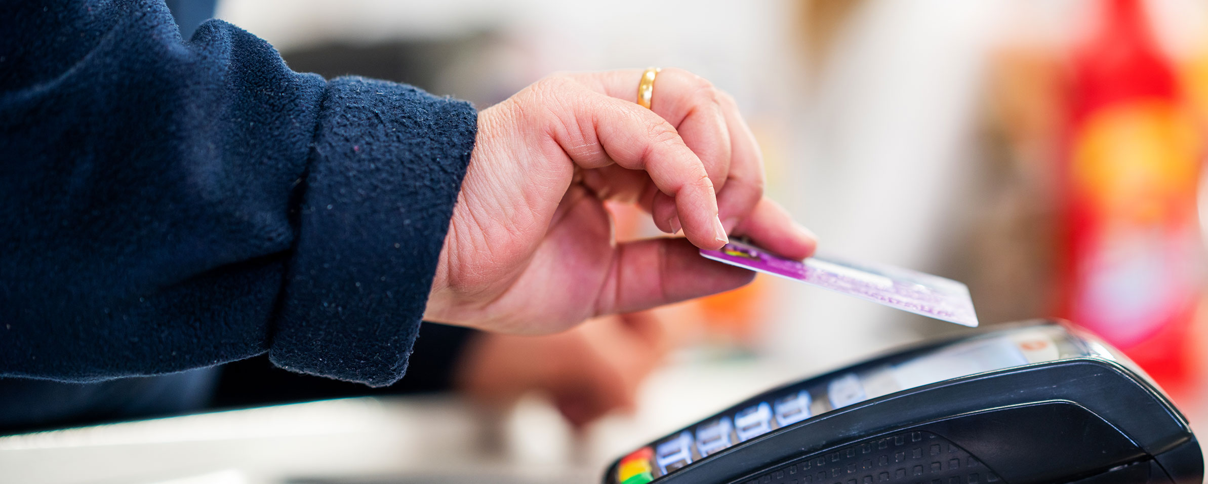 man playing for groceries with debit card