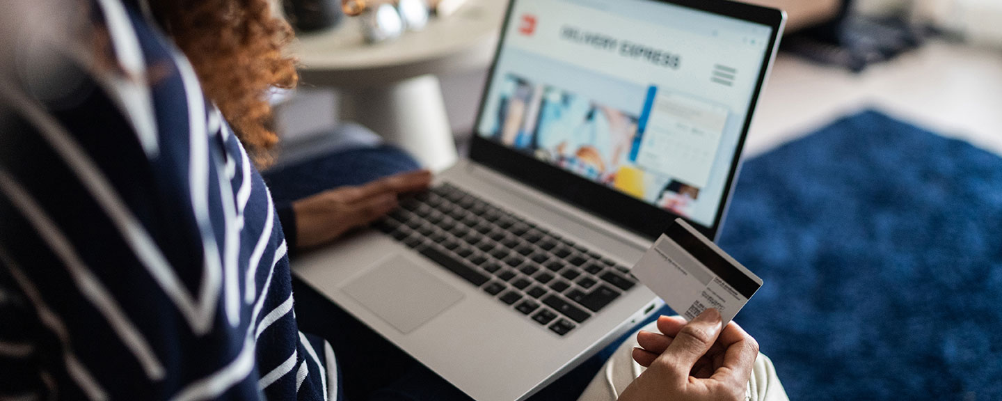 Woman using credit card to online shop