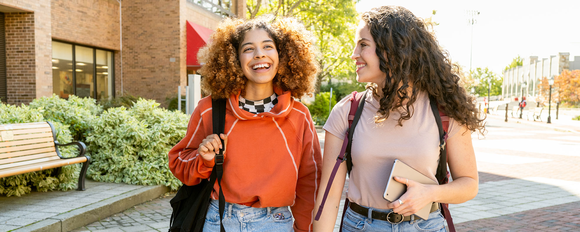 Two college girls walking and laughing