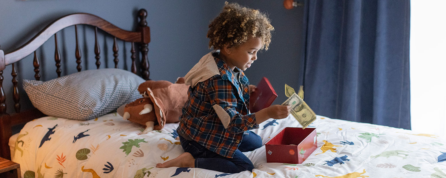 little boy putting money away in secret stash