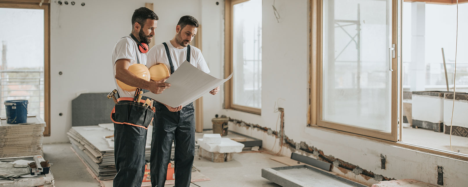 two contractors looking over blueprints