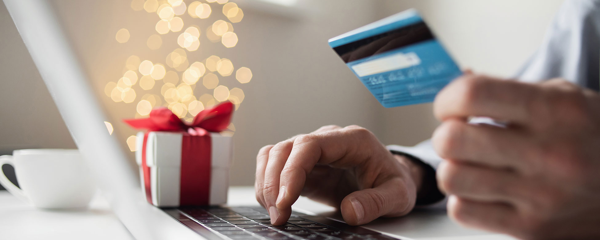 Hands typing on keyboard with credit card