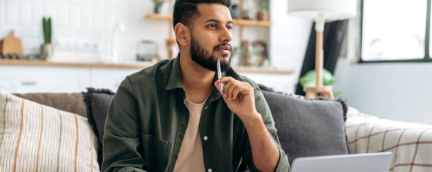 man thinking comfortably at home