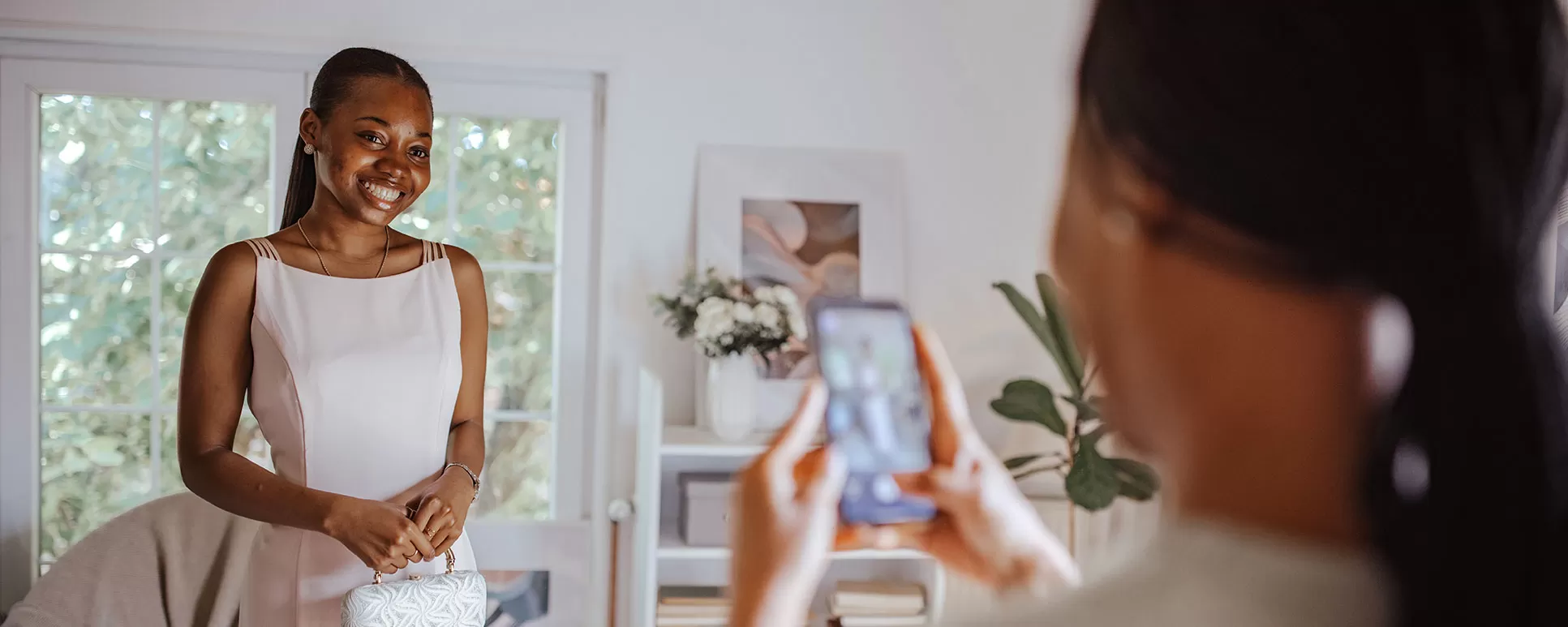 High school girl posing for her mom taking a photo in her room