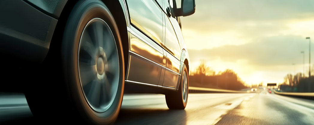 car on the road at sunrise