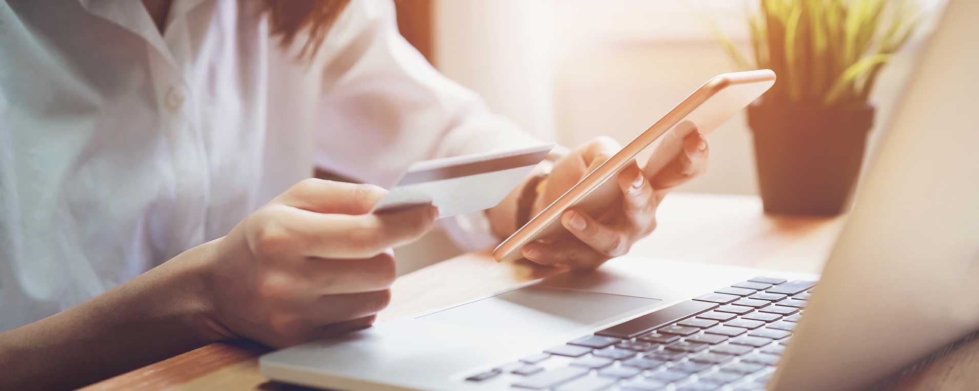 Woman making payment on laptop with credit card