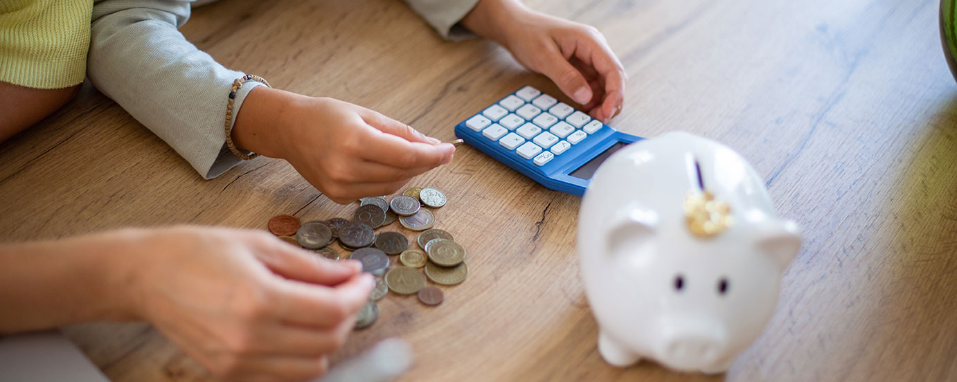 Parent helping child count coins