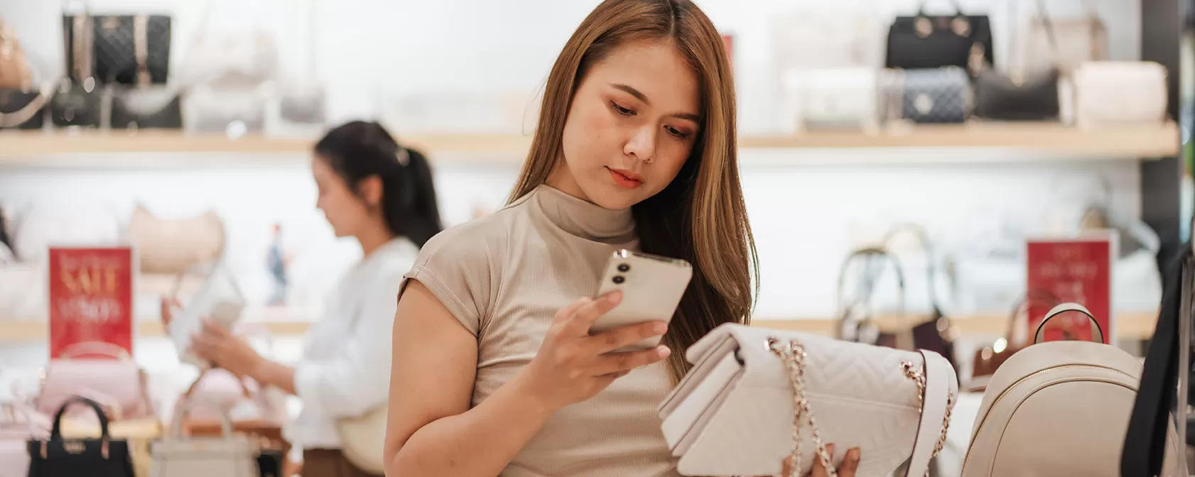 Woman looking at designer purse