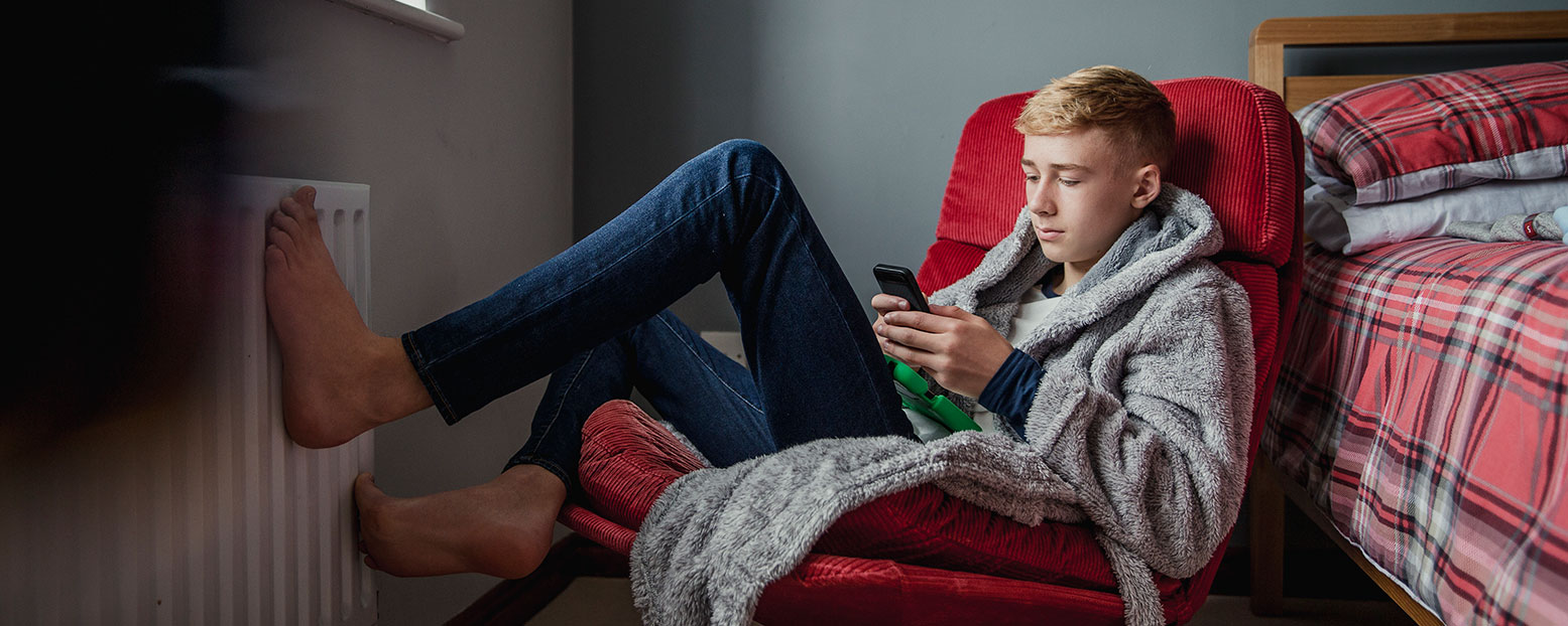 teenager on phone in chair