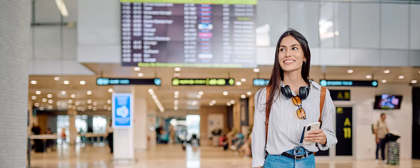 Woman walking in airport with luggage