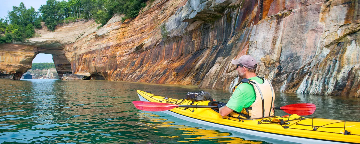 Man kayaking near Pictured Rocks National Lakeshore