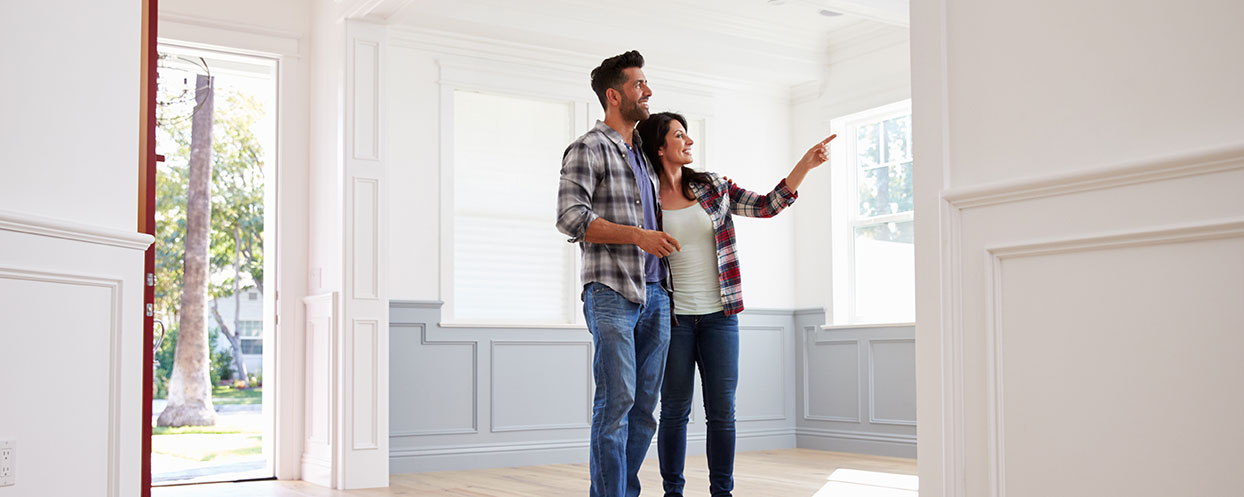 young couple looking at home interior