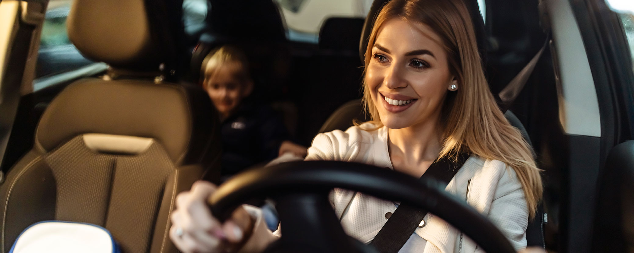 mother driving looking at son in rear view mirror