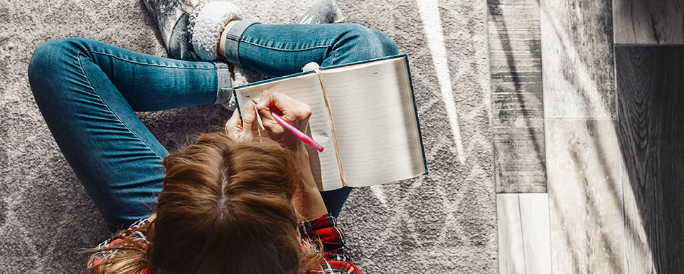 teen girl writing in journal