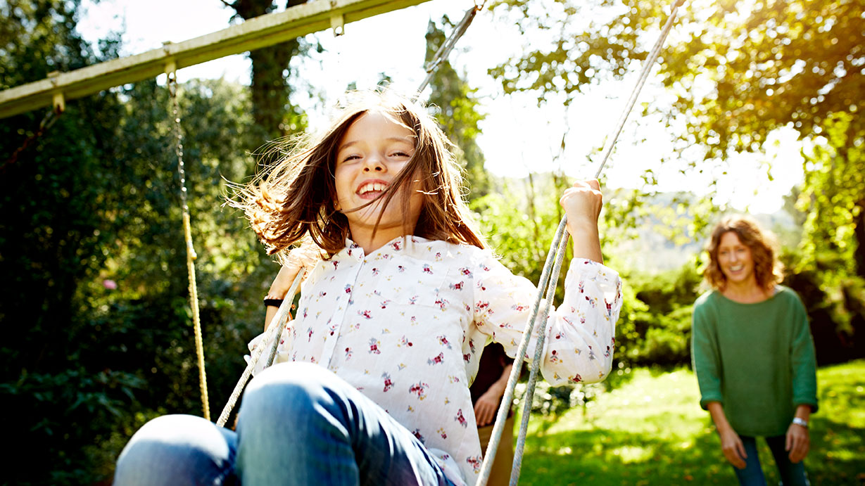 Child laughing on swing