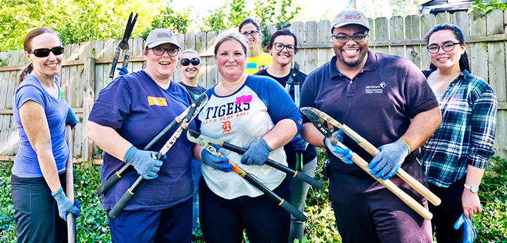 Team members volunteering outside.